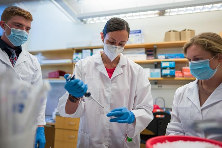 Research assistant and doctoral student Brandy Moser ‘23G, assistant professor Maria Carlota Dao, and undergraduate research assistant Jason Hansen ’22 work in Dao’s lab. 